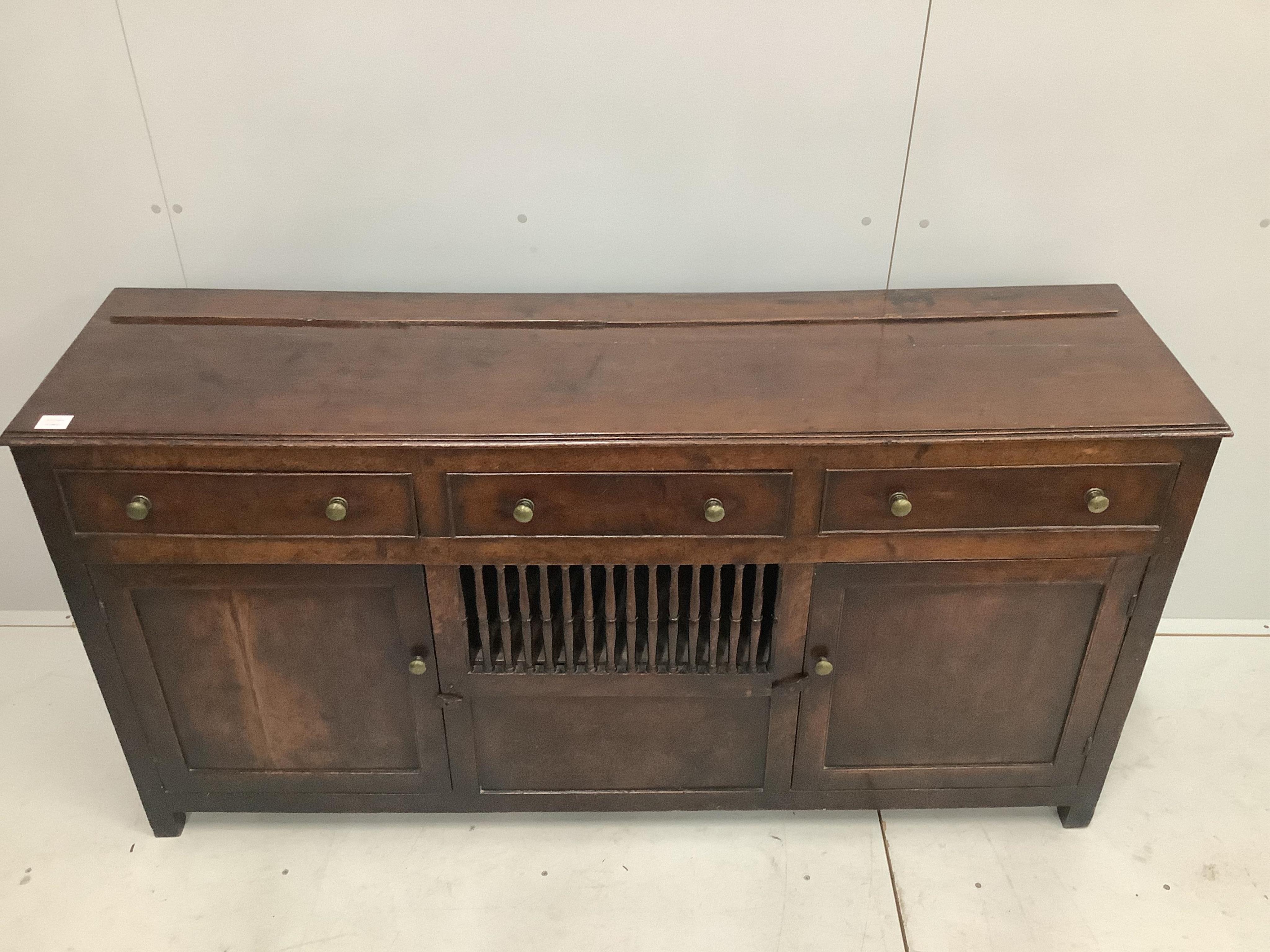 An 18th century North Wales oak enclosed dresser with central spindled glass or food compartment, width 163cm, depth 43cm, height 84cm. Condition - light wear but essentially good. Purchased from the specialist oak deale